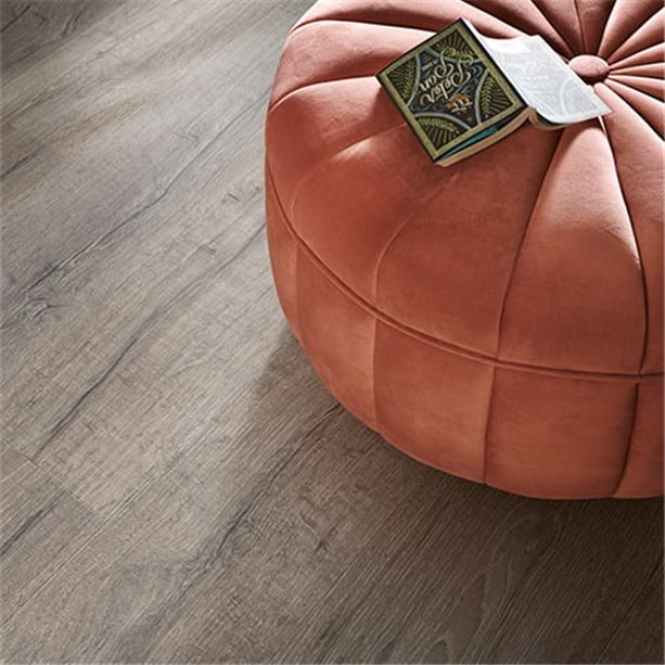 close up of dark grey vinyl floor with an orange pouf